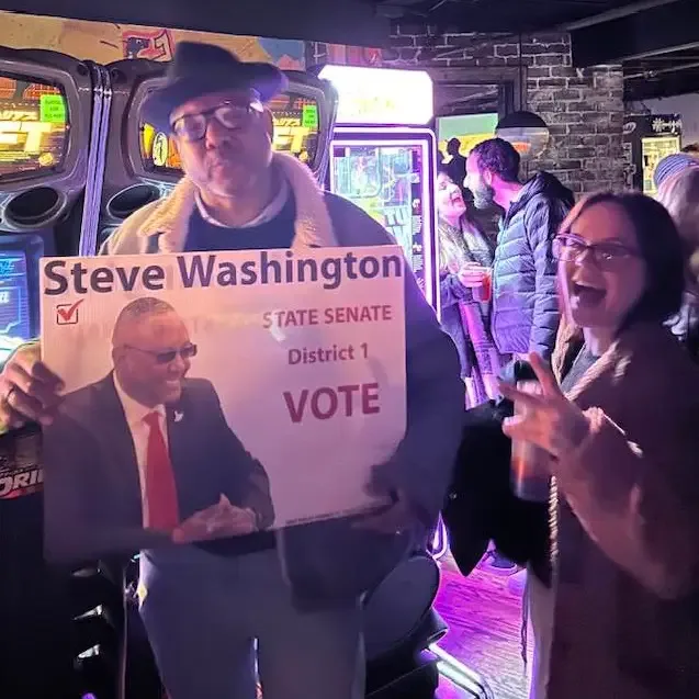 Supporters holding a Steve Washington campaign sign